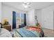 Well-lit bedroom with a ceiling fan, a big window, and a closet for storage at 3935 Capri Coast Dr, Plant City, FL 33565