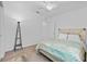 Comfortable bedroom with neutral colored walls, carpet, and a decorative floor lamp at 3935 Capri Coast Dr, Plant City, FL 33565