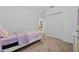 Cozy bedroom features neutral carpeting and a white framed bed with closet space at 3935 Capri Coast Dr, Plant City, FL 33565