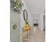 Bright foyer with a console table, decorative mirror, and a view into the home's living space at 3935 Capri Coast Dr, Plant City, FL 33565
