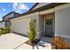 Inviting home exterior featuring a garage, a landscaped front yard, and a charming front door at 3935 Capri Coast Dr, Plant City, FL 33565