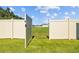 View of the gate to the backyard, revealing a large green space behind the property at 3935 Capri Coast Dr, Plant City, FL 33565