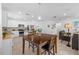Open concept kitchen with white cabinets, stainless appliances, granite counters, and adjoining living area at 3935 Capri Coast Dr, Plant City, FL 33565