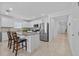Bright kitchen with stainless steel appliances, white cabinets, granite countertops, and center island at 3935 Capri Coast Dr, Plant City, FL 33565
