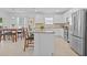 Bright kitchen features white cabinets, granite countertops, stainless steel appliances, and a spacious island at 3935 Capri Coast Dr, Plant City, FL 33565