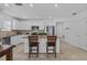 Open floor plan kitchen with seating at the island and stainless steel appliances at 3935 Capri Coast Dr, Plant City, FL 33565