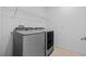 Functional laundry area with modern front-load washer and dryer, plus convenient wire shelving at 3935 Capri Coast Dr, Plant City, FL 33565