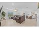 Bright living room with a ceiling fan, tile flooring, and a comfortable seating arrangement at 3935 Capri Coast Dr, Plant City, FL 33565