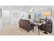 Bright living room with a comfortable brown leather sectional, tile flooring, and a ceiling fan at 3935 Capri Coast Dr, Plant City, FL 33565