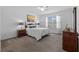 Bright main bedroom showcases carpeted floors, a ceiling fan, a king bed, and bedside tables at 3935 Capri Coast Dr, Plant City, FL 33565