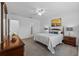 Spacious main bedroom features carpeted floors, a ceiling fan, a king bed, and dual bedside lamps at 3935 Capri Coast Dr, Plant City, FL 33565