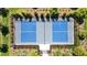 Aerial view of a fenced pickleball court with blue surface, showcasing the community's recreational facilities at 3935 Capri Coast Dr, Plant City, FL 33565