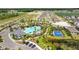 View of the sparkling community pool area with palm trees and a sports court at 3935 Capri Coast Dr, Plant City, FL 33565