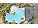Overhead view of a community pool featuring a unique shape, palm trees, and ample lounge areas at 3935 Capri Coast Dr, Plant City, FL 33565