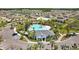 View of the sparkling community pool area with palm trees, playground and a clubhouse at 3935 Capri Coast Dr, Plant City, FL 33565