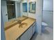 Bathroom featuring a vanity with double sinks, an adjacent toilet, and a shower/tub with gold trim at 400 Island Way # 1402, Clearwater Beach, FL 33767