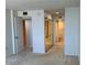 Spacious bedroom featuring neutral carpet, access to a bathroom, and a mirrored closet for ample storage at 400 Island Way # 1402, Clearwater Beach, FL 33767