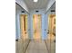 View of a hallway featuring large mirrored closets on either side, providing abundant storage space at 400 Island Way # 1402, Clearwater Beach, FL 33767