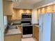 Well-maintained kitchen featuring light wood cabinets, updated appliances, and granite countertops at 400 Island Way # 1402, Clearwater Beach, FL 33767