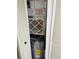 A water heater situated in a closet beside an air conditioning unit, all neatly arranged and accessible at 400 Island Way # 1402, Clearwater Beach, FL 33767