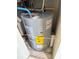 A close-up of the water heater, showcasing its energy-efficient design and recent installation date at 400 Island Way # 1402, Clearwater Beach, FL 33767