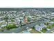 An aerial view of a residential waterfront home on a canal with boat docks and a red roof at 4299 Bellaire Dr, Hernando Beach, FL 34607