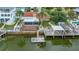 Inviting backyard with a screened lanai, waterside deck, boat dock, and room for entertaining and relaxing at 4299 Bellaire Dr, Hernando Beach, FL 34607