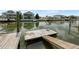 View of boat dock with a ladder on the water in a residential neighborhood at 4299 Bellaire Dr, Hernando Beach, FL 34607