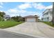 Well-maintained home with a neatly manicured lawn, a spacious driveway, and an attached garage in a sunny setting at 4299 Bellaire Dr, Hernando Beach, FL 34607