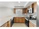 Charming kitchen featuring stainless steel appliances, wood cabinets, and neutral countertops at 4299 Bellaire Dr, Hernando Beach, FL 34607