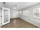 Spacious living room featuring wood-style floors, white walls, a ceiling fan, and a glass door at 4299 Bellaire Dr, Hernando Beach, FL 34607