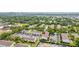 Aerial view of a townhouse community surrounded by mature trees and ample parking spaces at 4314 La Mora Ct, Tampa, FL 33611