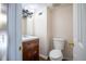 A well-lit half-bathroom features a traditional vanity with a wood cabinet and a standard toilet, creating a functional space at 4314 La Mora Ct, Tampa, FL 33611