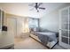 Cozy bedroom features a modern bed, neutral tones, and a ceiling fan with lighting at 4314 La Mora Ct, Tampa, FL 33611