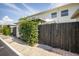 Exterior home view with a wooden privacy fence and garden, enhancing the property's appeal with nature at 4314 La Mora Ct, Tampa, FL 33611