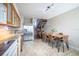 Bright kitchen with a dining table, modern appliances, and a view of the staircase at 4314 La Mora Ct, Tampa, FL 33611