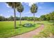 Beautiful park with walking paths, picnic tables, and towering palm trees offering a serene outdoor space at 4314 La Mora Ct, Tampa, FL 33611