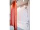 Shower features a bathtub with a bright orange curtain and a shower head, creating a clean and functional bathroom space at 4314 La Mora Ct, Tampa, FL 33611