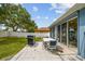 A backyard featuring a patio area with a grill and chairs, perfect for outdoor entertaining at 4612 35Th E Ave, Palmetto, FL 34221