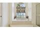 This bathroom features a marble surround soaking tub with a window for natural light at 4612 35Th E Ave, Palmetto, FL 34221