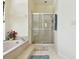 Bright bathroom features glass-enclosed shower and neutral tile surround at 4612 35Th E Ave, Palmetto, FL 34221