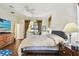 Cozy bedroom featuring warm wood flooring, a ceiling fan and a sliding glass door at 4612 35Th E Ave, Palmetto, FL 34221