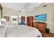 Bedroom includes wood flooring, ceiling fan, and a bathroom with a soaking tub at 4612 35Th E Ave, Palmetto, FL 34221