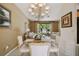 Elegant dining room with chandelier, glass table, and views to the living room with comfortable seating at 4612 35Th E Ave, Palmetto, FL 34221