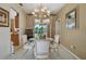 Formal dining room with neutral walls and seating for four beneath an ornate chandelier at 4612 35Th E Ave, Palmetto, FL 34221