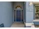 Close up of the blue front door with sidelights, arched transom and house numbers at 4612 35Th E Ave, Palmetto, FL 34221