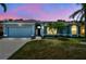 Charming single-story blue home with manicured lawn and well-maintained landscaping at 4612 35Th E Ave, Palmetto, FL 34221