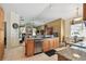Open concept kitchen with granite counters and stainless appliances connected to dining and living area at 4612 35Th E Ave, Palmetto, FL 34221