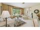 Bright living room with large windows, neutral decor, and comfortable seating creating a welcoming atmosphere at 4612 35Th E Ave, Palmetto, FL 34221