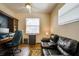 Bright and sunny office with a dark built-in desk and comfortable seating area at 4612 35Th E Ave, Palmetto, FL 34221